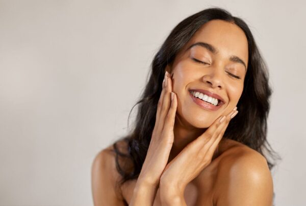 woman smiling after getting a facelift and fillers in NYC