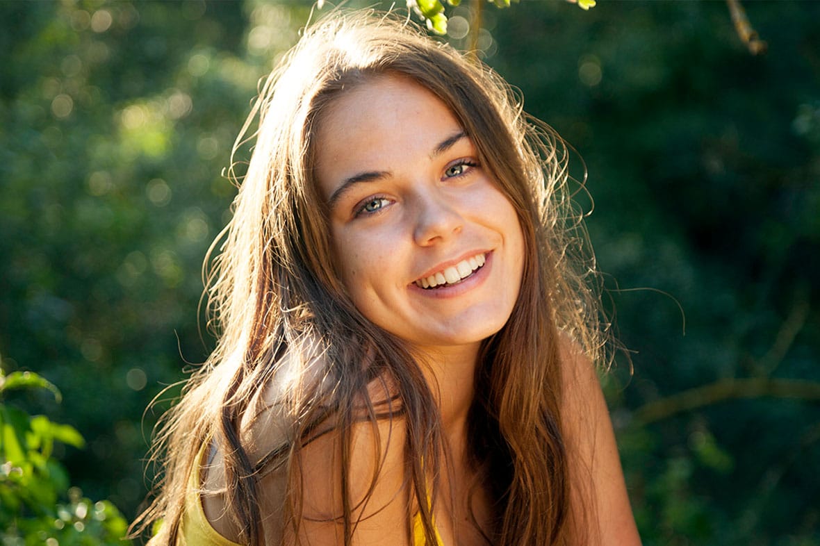 teenage girl smiling after getting a rhinoplasty in NYC